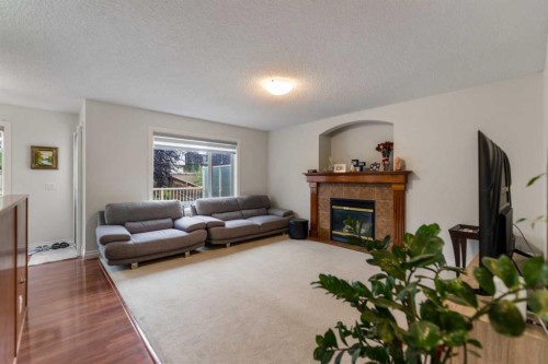 10 Evansmeade Manor Nw, Calgary, AB - Indoor Photo Showing Living Room With Fireplace