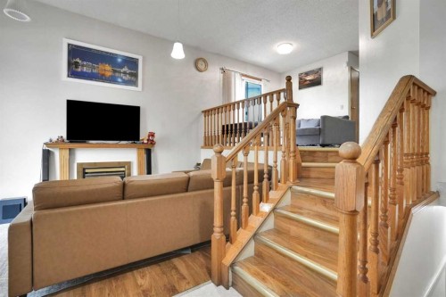 28 Martinridge Road Ne, Calgary, AB - Indoor Photo Showing Other Room With Fireplace