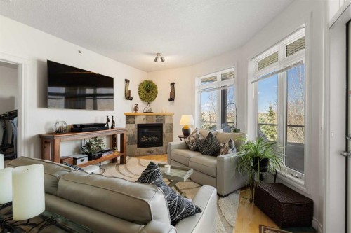 304-8 Hemlock Crescent Sw, Calgary, AB - Indoor Photo Showing Living Room With Fireplace