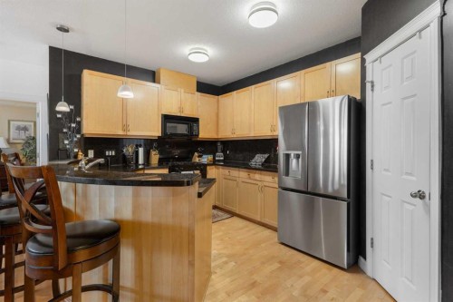 304-8 Hemlock Crescent Sw, Calgary, AB - Indoor Photo Showing Kitchen With Double Sink