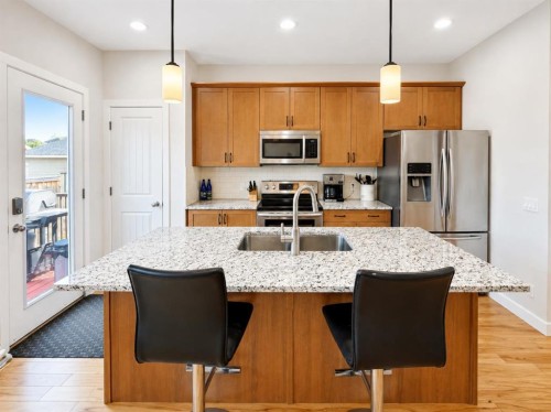 12 Fireside Bend, Cochrane, AB - Indoor Photo Showing Kitchen With Stainless Steel Kitchen With Double Sink With Upgraded Kitchen