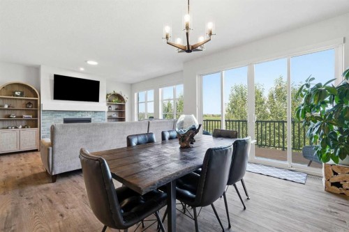 129 Wolf Hollow Villas Se, Calgary, AB - Indoor Photo Showing Dining Room With Fireplace