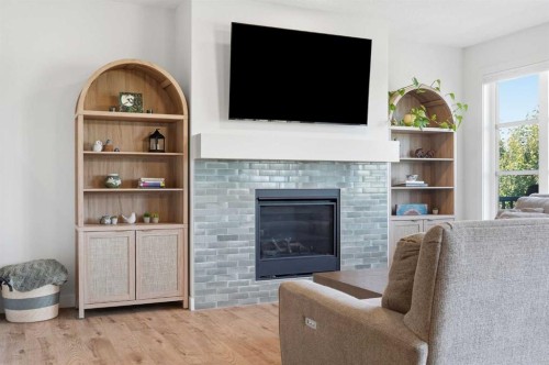 129 Wolf Hollow Villas Se, Calgary, AB - Indoor Photo Showing Living Room With Fireplace