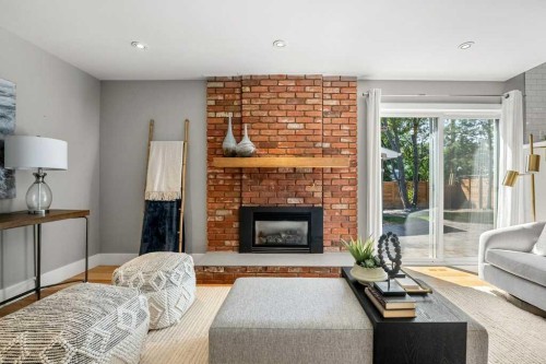 10411 Maplemont Road Se, Calgary, AB - Indoor Photo Showing Living Room With Fireplace