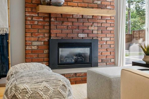 10411 Maplemont Road Se, Calgary, AB - Indoor Photo Showing Living Room With Fireplace