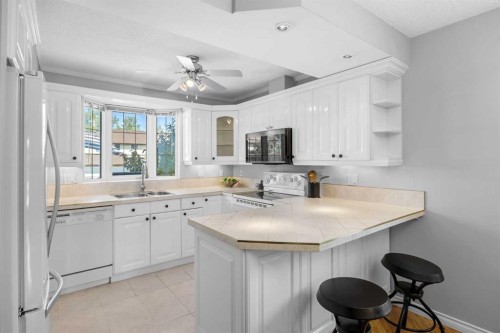 75 Woodhill Court Sw, Calgary, AB - Indoor Photo Showing Kitchen With Double Sink