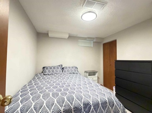 151 Sandstone Place Nw, Calgary, AB - Indoor Photo Showing Bedroom