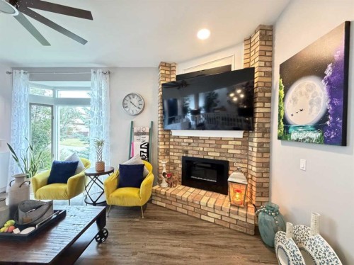 151 Sandstone Place Nw, Calgary, AB - Indoor Photo Showing Living Room With Fireplace