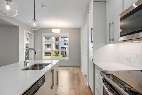 203-383 Smith Street Nw, Calgary, AB - Indoor Photo Showing Kitchen With Stainless Steel Kitchen With Double Sink With Upgraded Kitchen