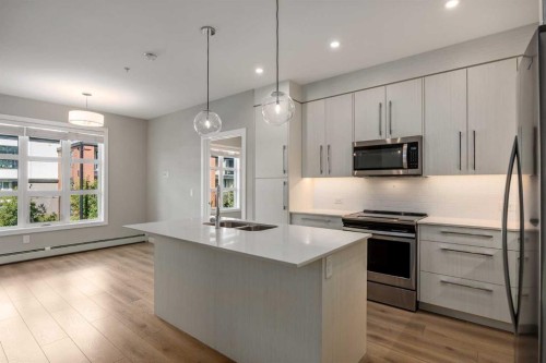 203-383 Smith Street Nw, Calgary, AB - Indoor Photo Showing Kitchen With Stainless Steel Kitchen With Double Sink With Upgraded Kitchen