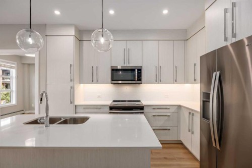 203-383 Smith Street Nw, Calgary, AB - Indoor Photo Showing Kitchen With Stainless Steel Kitchen With Double Sink With Upgraded Kitchen