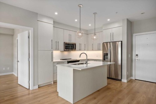 203-383 Smith Street Nw, Calgary, AB - Indoor Photo Showing Kitchen With Stainless Steel Kitchen With Upgraded Kitchen