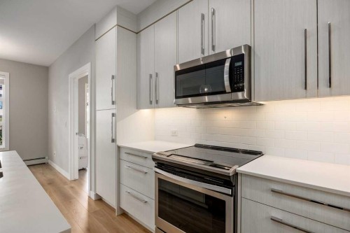 203-383 Smith Street Nw, Calgary, AB - Indoor Photo Showing Kitchen With Upgraded Kitchen