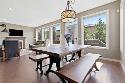 125 Walden Rise Se, Calgary, AB - Indoor Photo Showing Dining Room With Fireplace