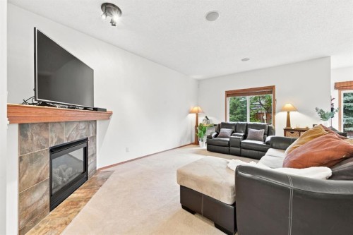 32 Tuscany Ravine Crescent Nw, Calgary, AB - Indoor Photo Showing Living Room With Fireplace