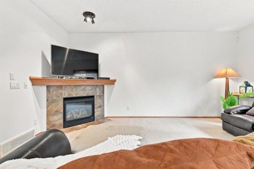 32 Tuscany Ravine Crescent Nw, Calgary, AB - Indoor Photo Showing Living Room With Fireplace