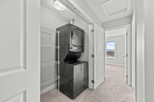 304 Jumping Pound Common, Cochrane, AB - Indoor Photo Showing Laundry Room