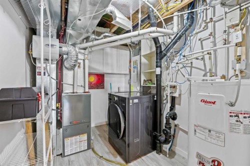 304 Jumping Pound Common, Cochrane, AB - Indoor Photo Showing Laundry Room