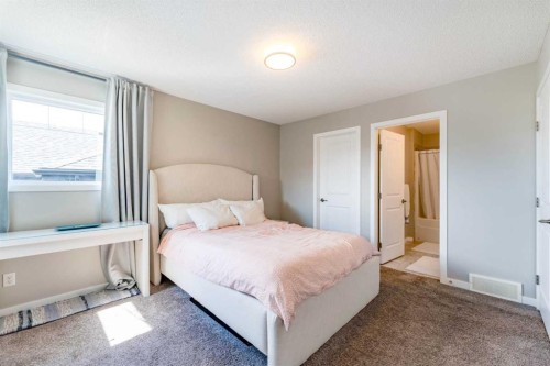 359 Sunrise View, Cochrane, AB - Indoor Photo Showing Bedroom
