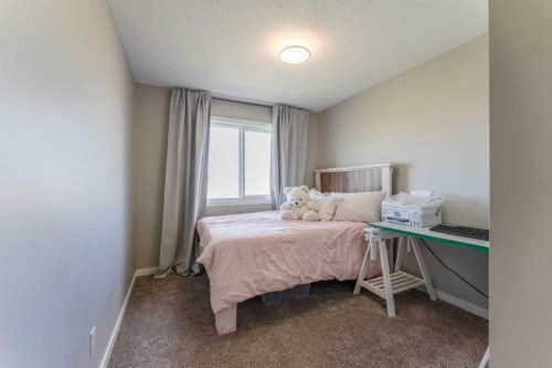 359 Sunrise View, Cochrane, AB - Indoor Photo Showing Bedroom