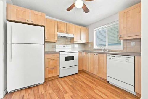 2-7734 Bowness Road Nw, Calgary, AB - Indoor Photo Showing Kitchen With Double Sink