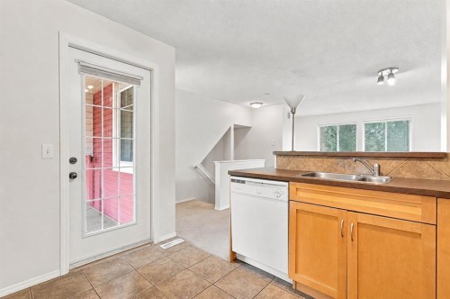 106 Panamount Drive Nw, Calgary, AB - Indoor Photo Showing Kitchen With Double Sink