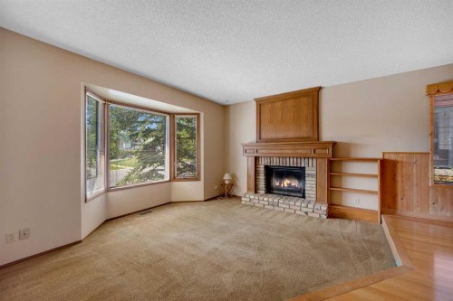 124 Macewan Drive Nw, Calgary, AB - Indoor Photo Showing Living Room With Fireplace