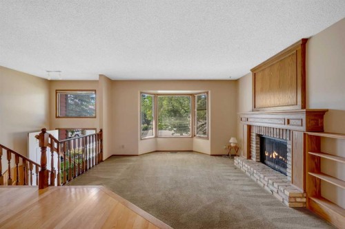 124 Macewan Drive Nw, Calgary, AB - Indoor Photo Showing Living Room With Fireplace