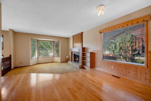 124 Macewan Drive Nw, Calgary, AB - Indoor Photo Showing Living Room With Fireplace