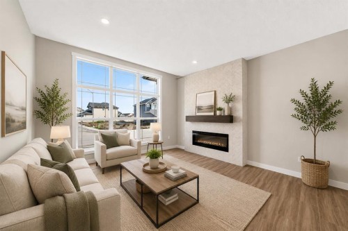 1069 Bayview Crescent Sw, Airdrie, AB - Indoor Photo Showing Living Room With Fireplace