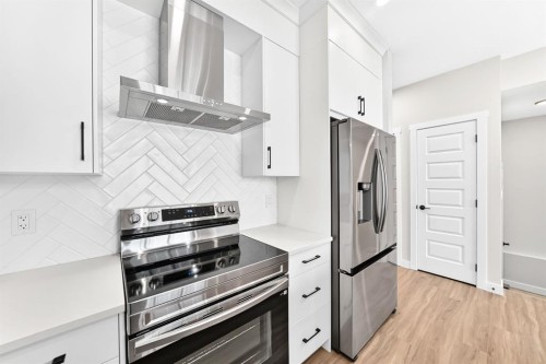 1069 Bayview Crescent Sw, Airdrie, AB - Indoor Photo Showing Kitchen With Stainless Steel Kitchen