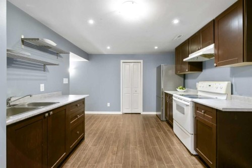 135 Manora Hill Ne, Calgary, AB - Indoor Photo Showing Kitchen With Double Sink