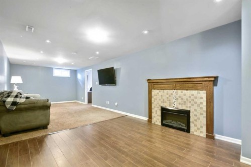 135 Manora Hill Ne, Calgary, AB - Indoor Photo Showing Living Room With Fireplace