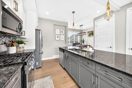 58 Precedence Link, Cochrane, AB - Indoor Photo Showing Kitchen With Double Sink With Upgraded Kitchen