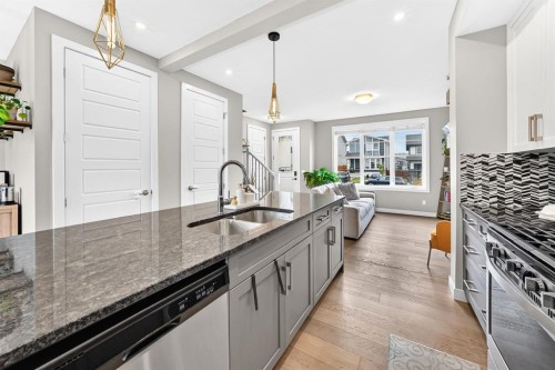58 Precedence Link, Cochrane, AB - Indoor Photo Showing Kitchen With Double Sink With Upgraded Kitchen
