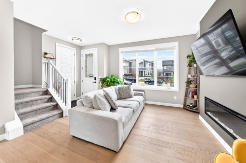 58 Precedence Link, Cochrane, AB - Indoor Photo Showing Living Room With Fireplace