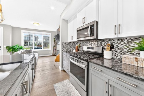 58 Precedence Link, Cochrane, AB - Indoor Photo Showing Kitchen With Upgraded Kitchen