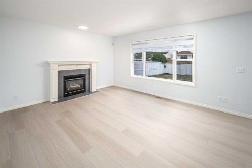 859 Harvest Hills Drive Ne, Calgary, AB - Indoor Photo Showing Living Room With Fireplace