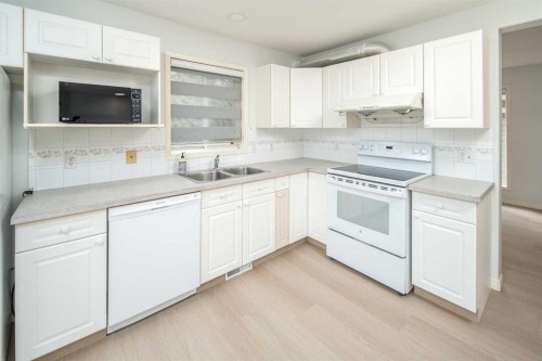 859 Harvest Hills Drive Ne, Calgary, AB - Indoor Photo Showing Kitchen With Double Sink