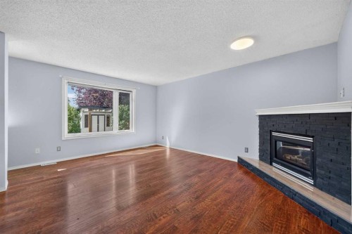 446 Harvest Hills Drive Ne, Calgary, AB - Indoor Photo Showing Living Room With Fireplace