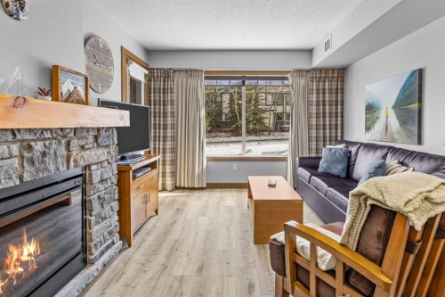 3106-250 2Nd Avenue, Dead Man'S Flats, AB - Indoor Photo Showing Living Room With Fireplace