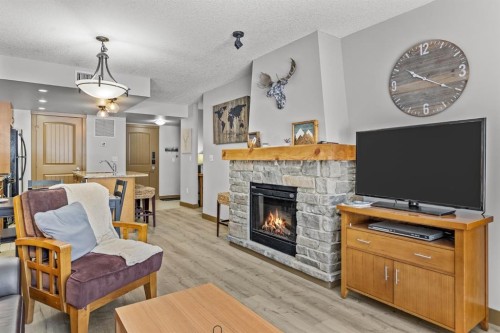 3106-250 2Nd Avenue, Dead Man'S Flats, AB - Indoor Photo Showing Living Room With Fireplace