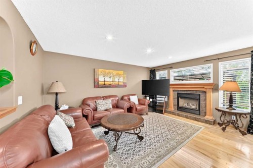 144 Cougarstone Common Sw, Calgary, AB - Indoor Photo Showing Living Room With Fireplace