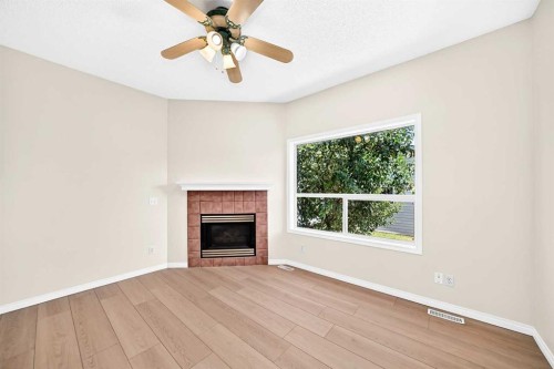 94 Arbour Wood Mews Nw, Calgary, AB - Indoor Photo Showing Living Room With Fireplace