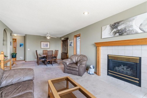 48 Headlands Close, Cochrane, AB - Indoor Photo Showing Living Room With Fireplace