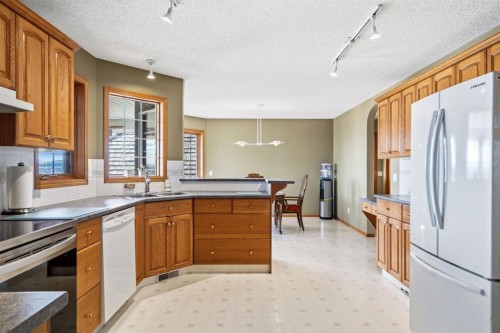 48 Headlands Close, Cochrane, AB - Indoor Photo Showing Kitchen With Double Sink