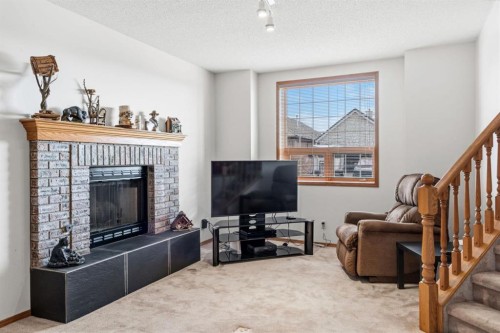 48 Headlands Close, Cochrane, AB - Indoor Photo Showing Living Room With Fireplace