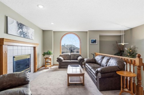 48 Headlands Close, Cochrane, AB - Indoor Photo Showing Living Room With Fireplace