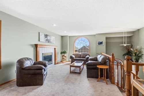 48 Headlands Close, Cochrane, AB - Indoor Photo Showing Living Room With Fireplace