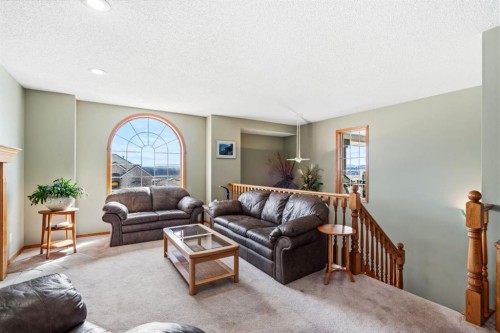 48 Headlands Close, Cochrane, AB - Indoor Photo Showing Living Room With Fireplace